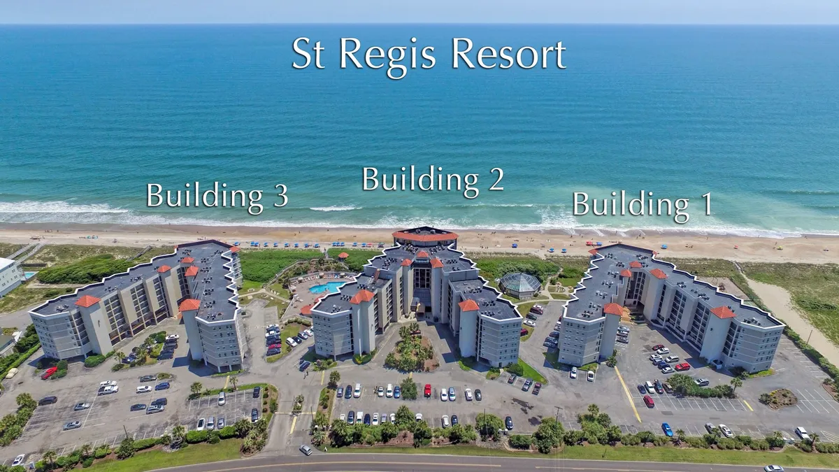 A broad exterior view showcasing three labeled buildings, a sparkling swimming pool, landscaped gardens, and the sweeping ocean beyond. The scene is lively yet serene, evoking both recreational fun and coastal serenity.